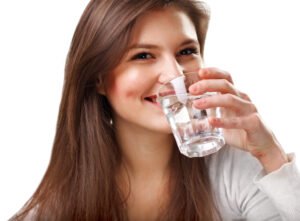 woman drinking water as advised by her Dentist in Rescue CA